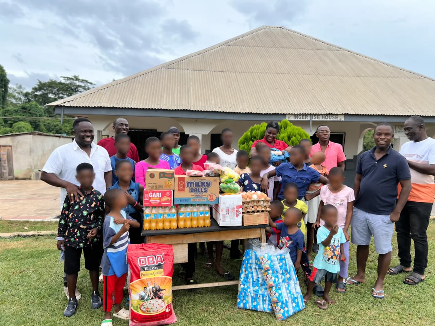 Community members gathered around donated essential supplies